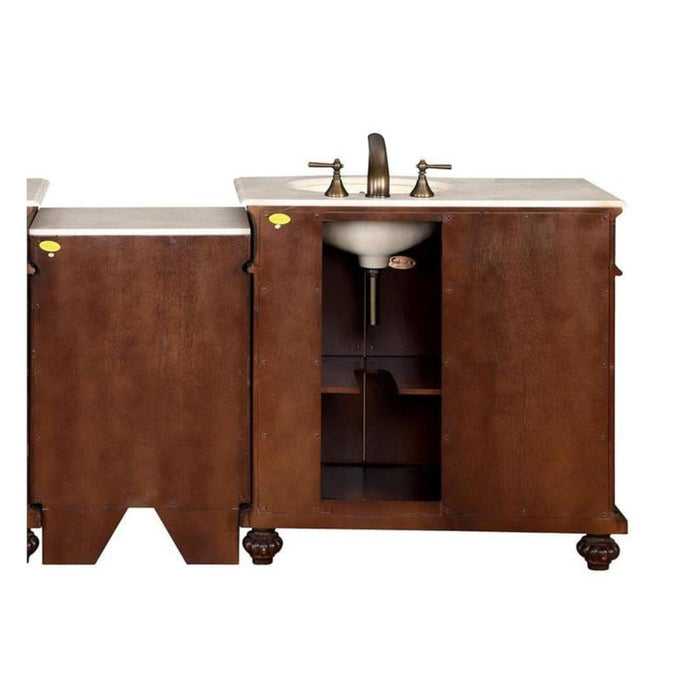 Dark wood bathroom vanity with white marble top and oval sink, bronze faucet fixtures, and open storage shelf.