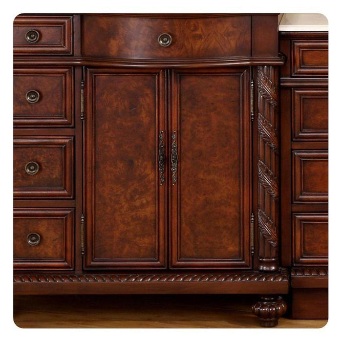 Rich mahogany wooden cabinetry with ornate carved details, decorative pulls, and central double doors with elegant handles.