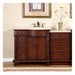 Elegant wooden bathroom vanity with rich brown finish, white marble top, multiple drawers, and center cabinet with decorative hardware.