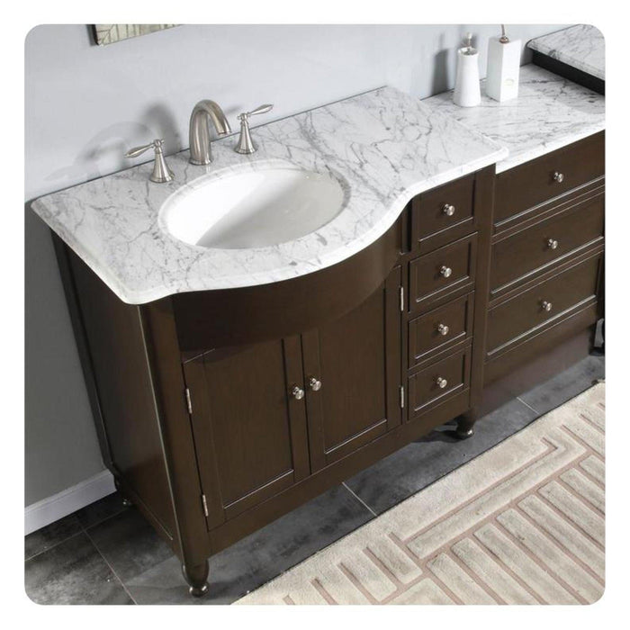 Dark brown bathroom vanity with white marble countertop, oval undermount sink, and brushed nickel faucet fixtures.
