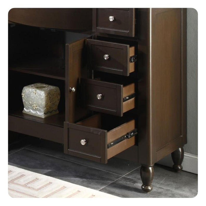 Dark wooden side table with three open drawers and decorative round knobs, sitting on turned legs with a textured stone object on an open shelf.