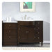 Dark wood bathroom vanity with white marble top, centered sink, and decorative chrome faucet and hardware