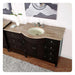 Dark wood bathroom vanity with curved travertine countertop and oval undermount sink, featuring multiple drawers and a white vase with a single flower.