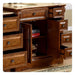 Rich mahogany bathroom vanity with multiple drawers, open cabinet door revealing interior shelves and decorative items.