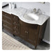 Dark wood bathroom vanity with white marble countertop, oval undermount sink, and brushed nickel faucet fixtures.