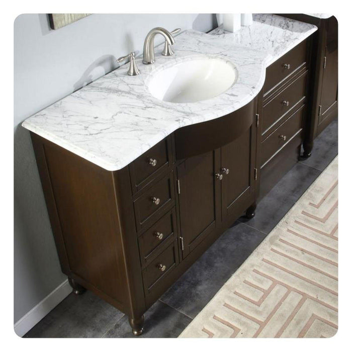 Dark wooden bathroom vanity with white marble countertop, oval sink, and brushed nickel faucet, featuring drawers and cabinet storage.