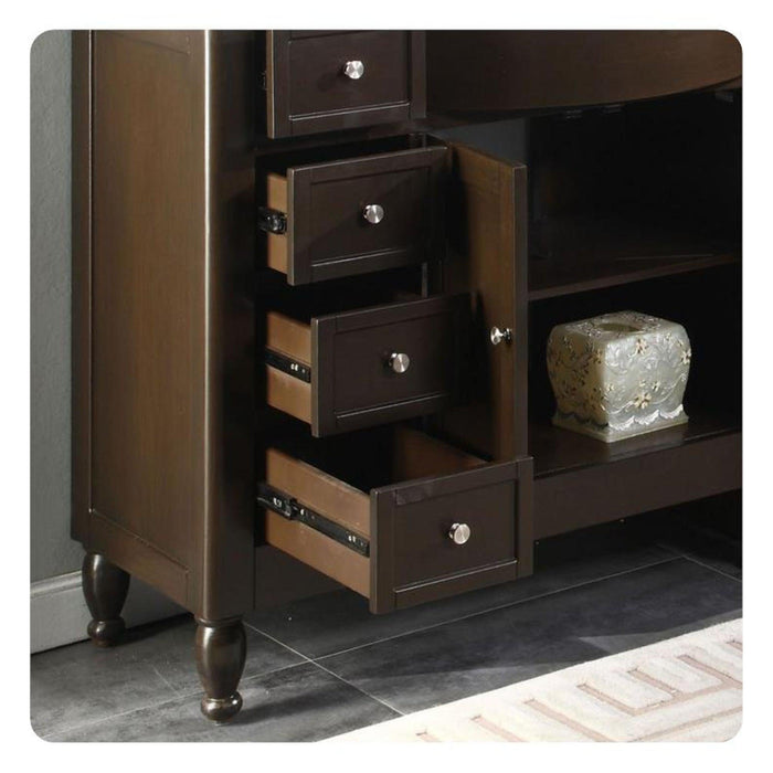 Dark wooden storage unit with three open drawers and decorative round knobs, sitting on turned legs with a ceramic vase on an adjacent shelf.