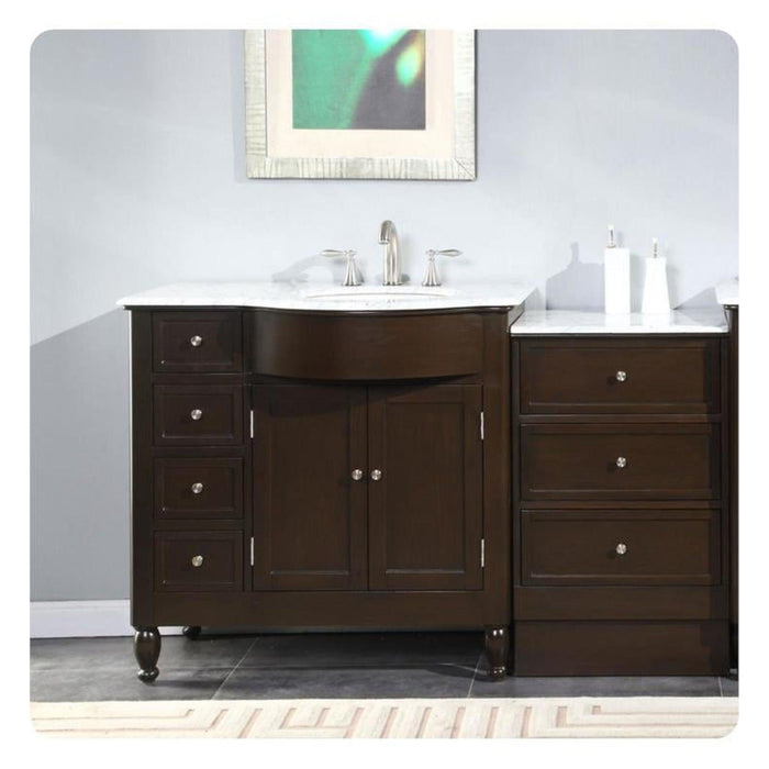 Dark wood bathroom vanity with white marble countertop, center sink, and decorative round legs, with matching side drawers.