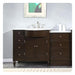 Dark wood bathroom vanity with white marble countertop, center sink, and decorative round legs, with matching side drawers.