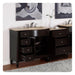 Dark wood bathroom vanity with marble top, multiple drawers open, with abstract gray artwork hanging above.