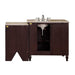 Dark brown bathroom vanity with beige stone top and undermount sink, featuring traditional faucet and decorative turned legs.