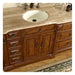 Rich wood bathroom vanity with marble countertop, white sink, and decorative metal faucet handles and drawer pulls.