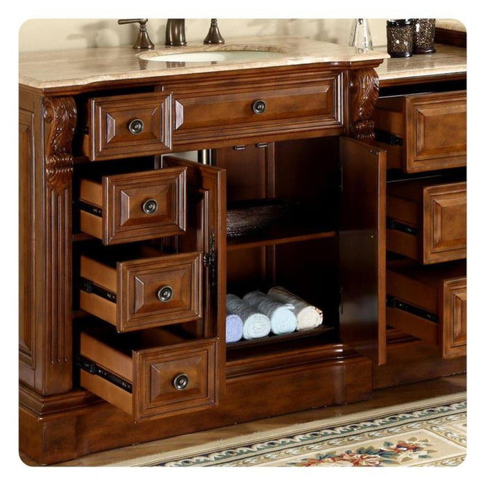 Rich wood bathroom vanity with multiple drawers, open shelving, and rolled white towels neatly stored on lower shelf