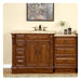 Rich wood bathroom vanity with ornate drawers, marble top sink, and decorative abstract art hanging above.