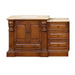 Traditional wooden bathroom vanity with carved columns, double doors, and three side drawers, topped with a light stone countertop and integrated sink.