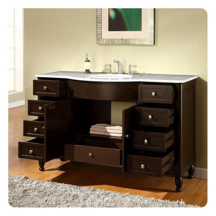 Dark wood bathroom vanity with marble top, multiple drawers open, white sink, and decorative green artwork hanging above.