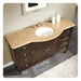Dark wood bathroom vanity with curved travertine countertop and oval white sink, featuring drawers and cabinet storage.