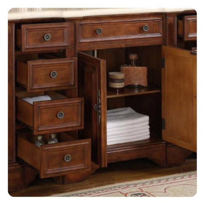 Rich wooden bathroom vanity with multiple drawers and open cabinet shelving, holding folded white towels and decorative containers