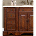 Rich wooden bathroom vanity with four drawers, cabinet doors, white marble top, and brass faucet fixtures.