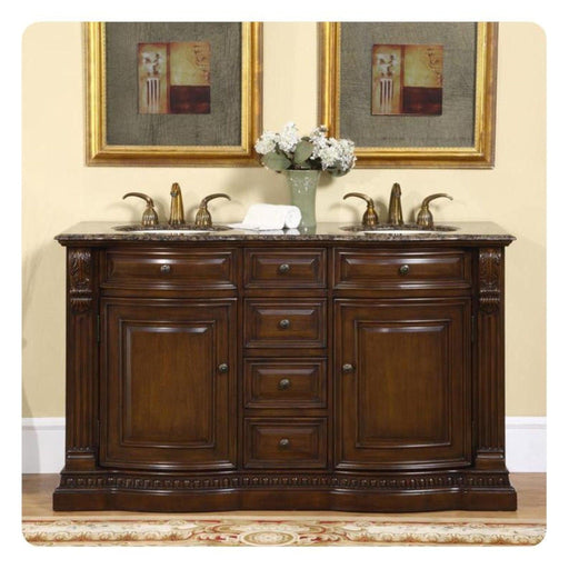 Elegant dark wood bathroom vanity with marble top, double sinks, ornate brass faucets, and hydrangeas in a mint green vase between two gold-framed artworks.