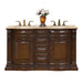 Rich wood bathroom vanity with marble top, two sinks, decorative hardware, and white flowers in amber vase.