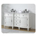 White double vanity with ornate details, black faucets, and four drawers centered between two cabinet doors