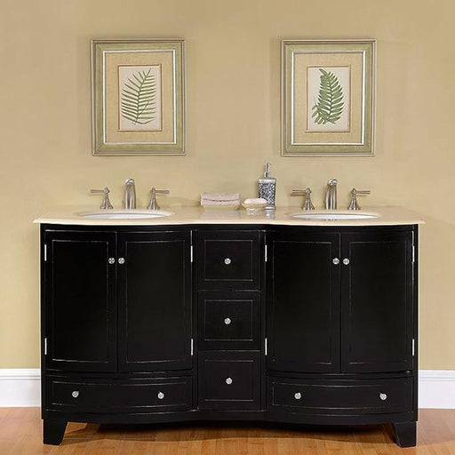 Black bathroom vanity with white marble top, double sinks, and framed botanical leaf prints hanging above on beige wall.