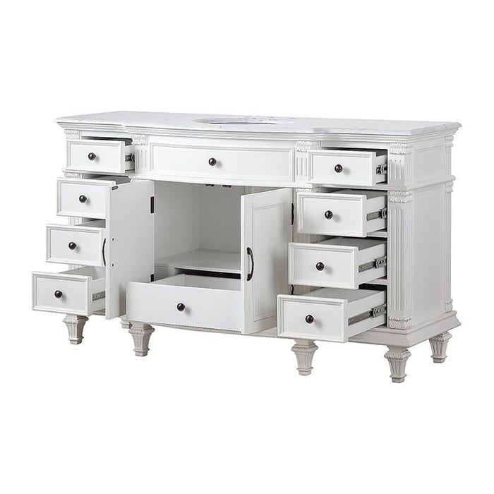 White vintage-style desk with multiple open drawers, ornate column details, and turned legs, showcasing intricate craftsmanship.