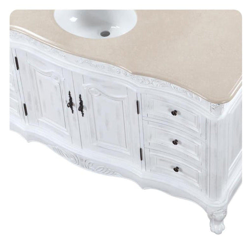 White vintage-style bathroom vanity with carved details, curved base, and round white sink