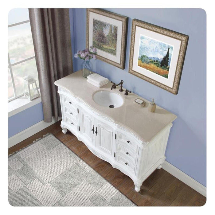 White bathroom vanity with oval sink, framed landscape art, and soft blue walls