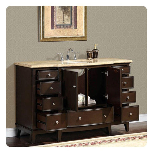 Dark wood bathroom vanity with marble top, multiple drawers open, displaying bathroom accessories and storage space.