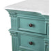 Vintage teal dresser with ornate carved details, white marble top, and dark bronze knobs, showing distressed paint finish.
