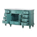 Turquoise vintage desk with multiple open drawers, ornate details, and turned legs, showcasing classic craftsmanship.
