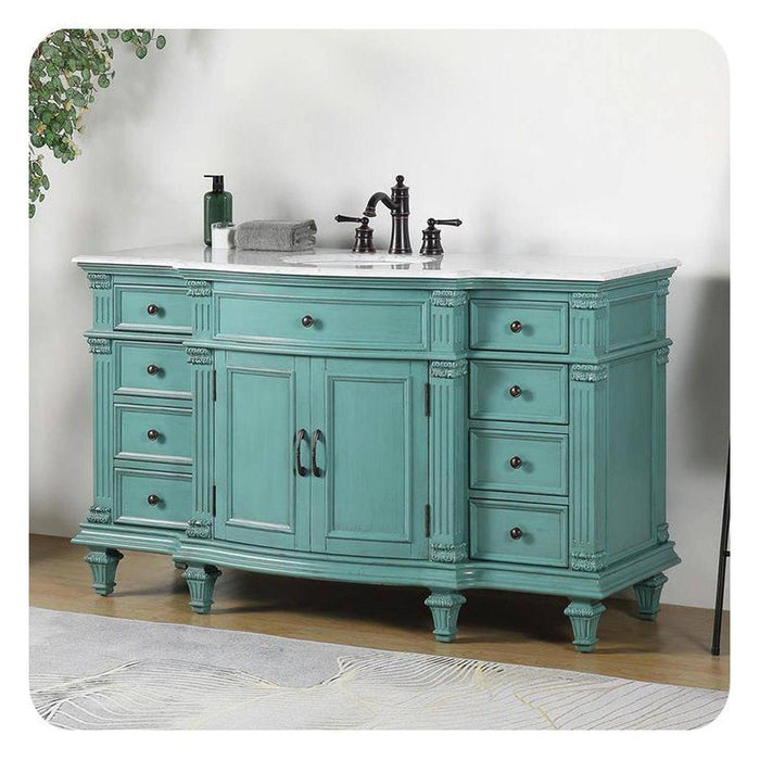 Vintage-style teal bathroom vanity with white marble top, six drawers, center cabinet, and ornate black faucet fixtures.