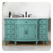 Vintage-style bathroom vanity in mint green, with ornate details, white marble top, and black fixtures.