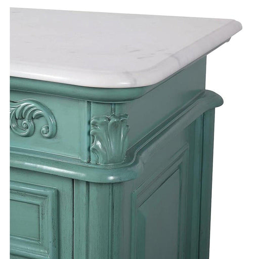 Ornate seafoam green furniture piece with white marble top, featuring decorative carved scrollwork and raised panel details.