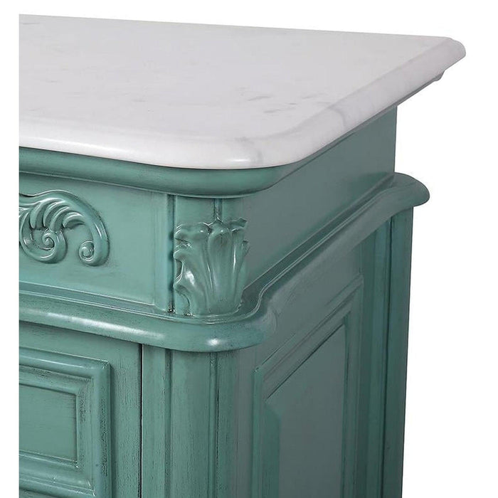 Ornate seafoam green furniture piece with white marble top, featuring decorative carved scrollwork and raised panel details.