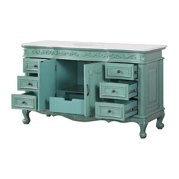 Vintage-style seafoam green bathroom vanity with ornate carved details, white marble top, and multiple open drawers.
