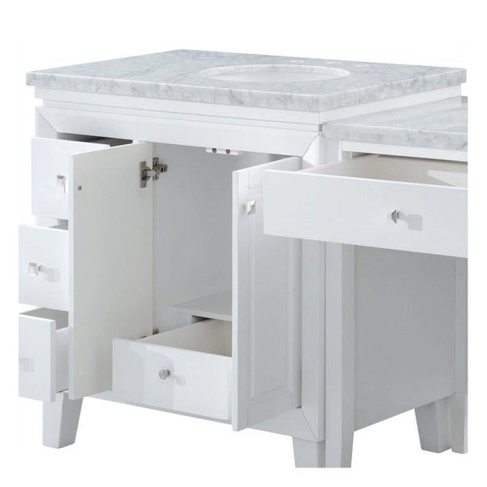 White bathroom vanity with marble top, open drawers and cabinet doors revealing interior storage space.