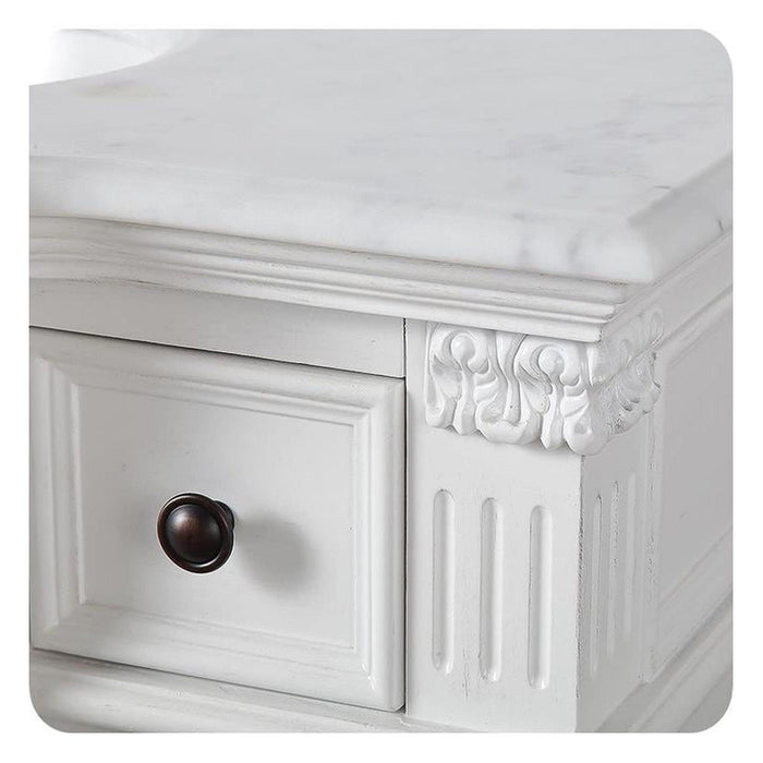 White ornate drawer with dark round knob, decorative carved corner and vertical panel details