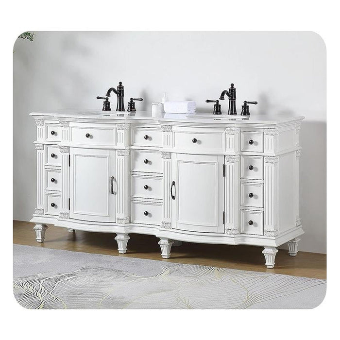 Elegant white bathroom vanity with ornate details, black faucets, and multiple drawers on decorative turned legs.