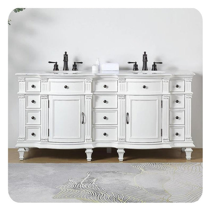 Elegant white double vanity with ornate details, black faucets, six drawers, two cabinets, and marble-style top, sitting on patterned floor.
