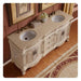 Antique white double-sink bathroom vanity with ornate carved details, curved design, and marble countertop, placed on hardwood floor with decorative rug.