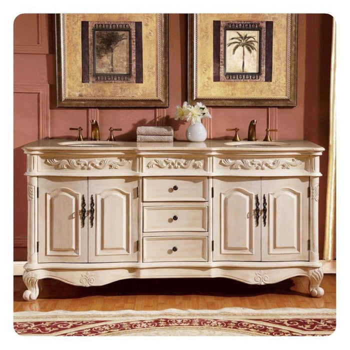 Ornate white double-sink bathroom vanity with carved details, tropical artwork, and elegant accessories on pink wall