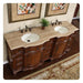 Elegant wooden bathroom vanity with curved design, double white sinks, travertine countertop, and ornate black fixtures. Small plant and abstract art decorate the space.