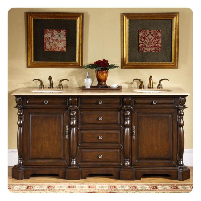 Rich wood double vanity with marble top, ornate gold-framed art, and red floral centerpiece