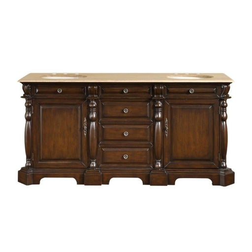 Dark wood bathroom vanity with ornate turned columns, cream marble top, three center drawers, and two side cabinets.