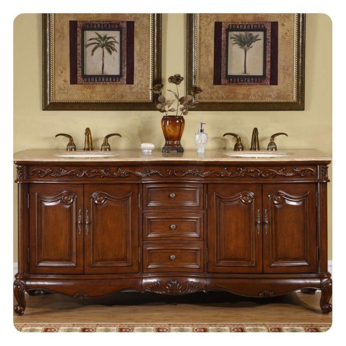 Ornate wooden double bathroom vanity with dark brown cabinets, marble countertop, two sinks, and framed palm tree art above.