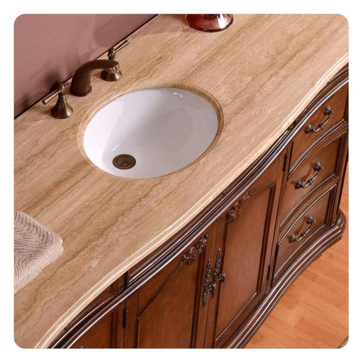 Elegant wooden bathroom vanity with curved edges, marble countertop, white undermount sink, and bronze fixtures.