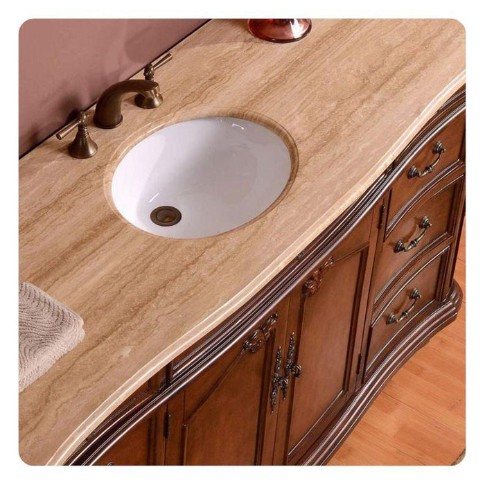 Elegant wooden bathroom vanity with curved edges, marble countertop, white undermount sink, and bronze fixtures.